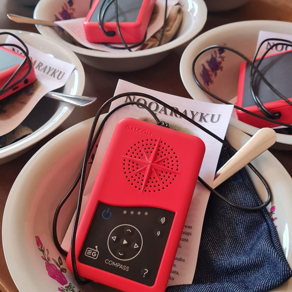 Red Galcom audio players with Scripture leaflets, prepared for distribution in the field